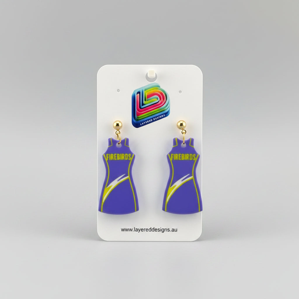 Pair of earrings on a Layered Designs card with a gray background