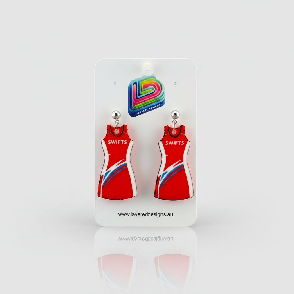 Pair of earrings on a display card with a black background